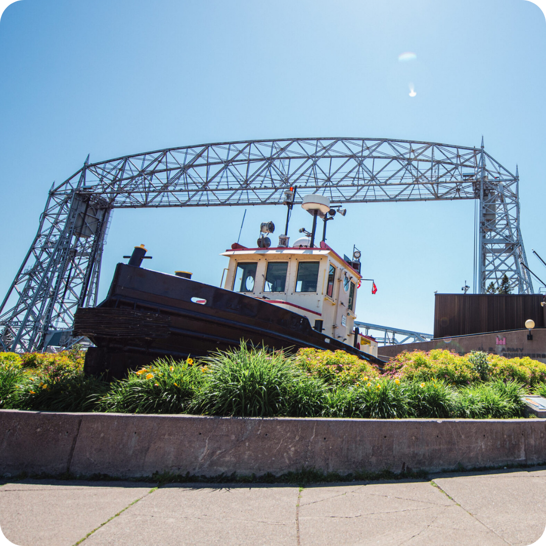 A photo of the Duluth Aerial Lift Bridge taken low from the ground looking up towards the sky